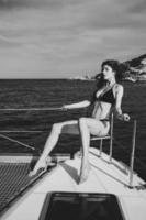 Fashion outdoor photo of beautiful young woman posing on a yachts