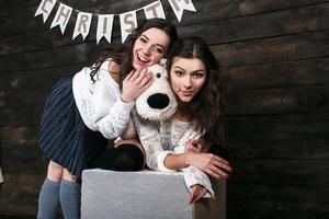 Family New Year's photos, one sister hugging each photo