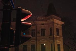 Traffic light on a snowy night photo