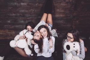 Four charming model posing on a vintage New Year's background photo