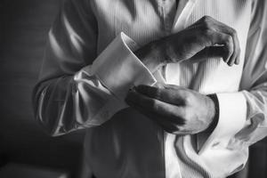 Groom prepares for wedding photo