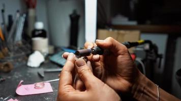 girl master processes the metal plate in the home workshop photo