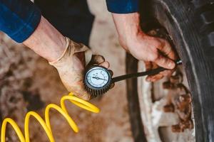 A man pumps air wheel with a compressor photo