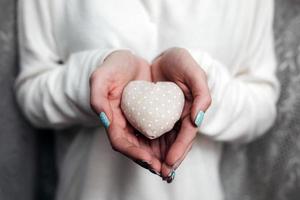 Girl holding a small lovely heart photo