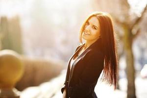 Beautiful emotional girl smiles on a background of the city photo