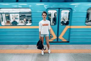 Beautiful young girl posing on metro station photo