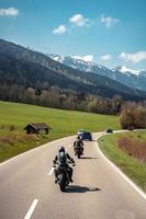 Two biker riding alone on mountainous road photo