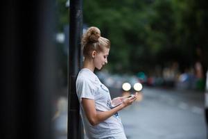 Cute girls with tablet on a bus station photo