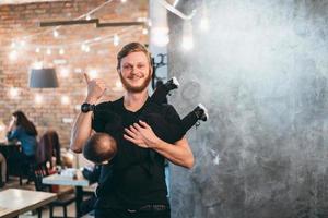 Dad is holding his little son in his arms photo