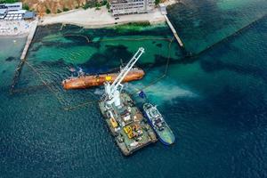 Top view of an old tanker that ran aground and overturned photo