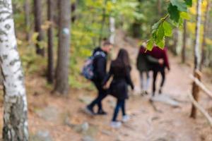 man and woman walking along hiking trail photo