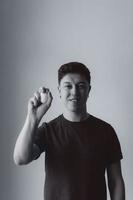 handsome man holding egg, black and white background photo