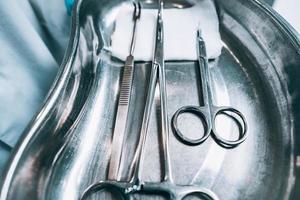 Several surgical instruments lie on a tray photo