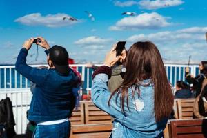 Man and woman take pictures of birds photo