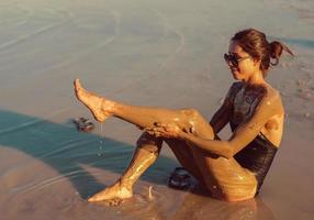 A young woman enjoying the natural mineral mud photo