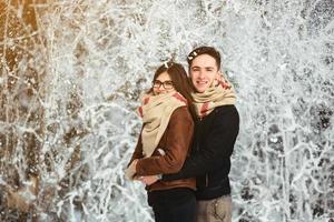 Happy couple in snow park photo