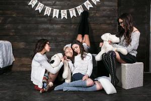 Four charming model posing on a vintage New Year's background photo