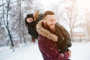 Young couple having fun on the snow photo