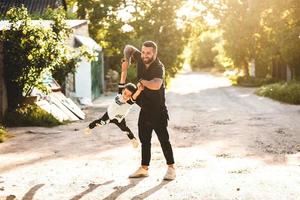 Dad plays with his little son on the photo