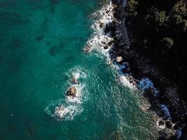 Drone top view of a sea cliff and a beach photo