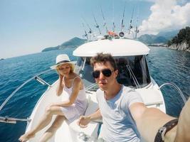 Couple resting on a yacht at sea photo