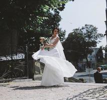 Bride posing in city photo