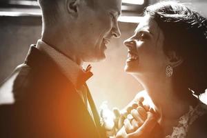 bride and groom on the background of a window. photo