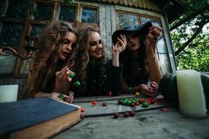 Three vintage witches perform magic ritual photo