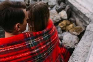 Young beautiful couple sitting on the beach photo