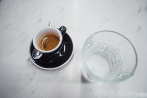 coffee mug and a glass of water on a table photo