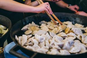 Dumplings with meat, onions on a big cast iron skillet. photo