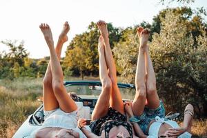 Three girls are lying on the trunk photo