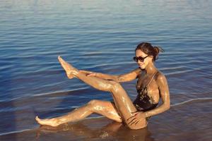 A young woman enjoying the natural mineral mud photo