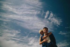 bride and groom  on the background of sky photo