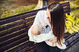 mother and two daughter rest on a bench photo