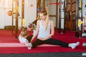 Mom and daughter together perform different exercises photo