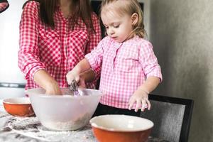 Mom and daughter together in the kitchen photo