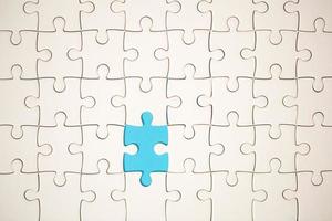 White part of jigsaw puzzle pieces on blue background. concepts of problem solving, business success, teamwork, Team playing jigsaw game incomplete, Texture photo with copy space for text