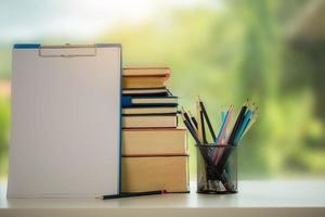 Object education green nature background with stack of ancient books or old bible, open paper book on wooden table with copy space. concept of back to school, research study photo