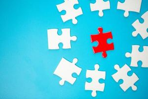White part of jigsaw puzzle pieces on blue background. concepts of problem solving, business success, teamwork, Team playing jigsaw game incomplete, Texture photo with copy space for text