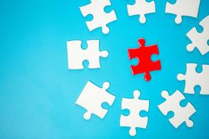 White part of jigsaw puzzle pieces on blue background. concepts of problem solving, business success, teamwork, Team playing jigsaw game incomplete, Texture photo with copy space for text