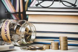 close-up education object with stack money coin-cash dollar and glass jar on background. Concept to saving money income for study, Calculating student finance costs and investment budget loan photo