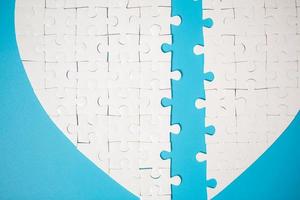 White part of jigsaw puzzle pieces on blue background. concepts of problem solving, business success, teamwork, Team playing jigsaw game incomplete, Texture photo with copy space for text