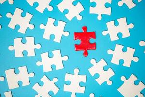 White part of jigsaw puzzle pieces on blue background. concepts of problem solving, business success, teamwork, Team playing jigsaw game incomplete, Texture photo with copy space for text