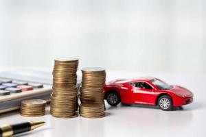 Car toy vehicle with stack coin money on background. Planning to manage transportation finance costs. Concept of car insurance business, saving buy - sale with tax and loan for new car. photo