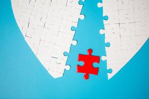 White part of jigsaw puzzle pieces on blue background. concepts of problem solving, business success, teamwork, Team playing jigsaw game incomplete, Texture photo with copy space for text