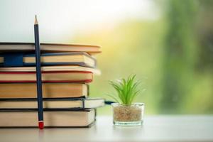 Object education green nature background with stack of ancient books or old bible, open paper book on wooden table with copy space. concept of back to school, research study photo