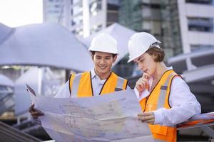 Team of diversity engineer is looking at the map to plan on construction project for urban planning design and real estate development concept photo