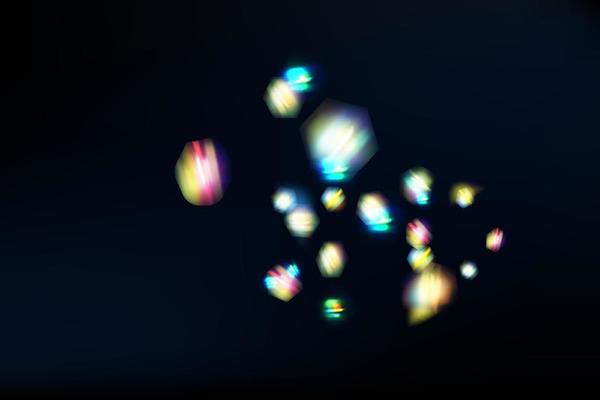 Rainbow highlights on a black background.Glare or reflection from water and glass.Glittering  particles for social media backgrounds, product presentations, photo shots.