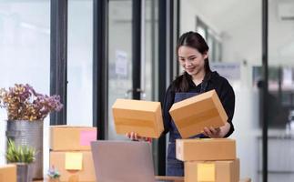 Startup small business SME, Entrepreneur owner checking online purchase shopping order to preparing pack product box. Selling online ideas concept photo